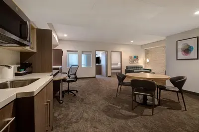 a kitchen and living room with a table and chairs at Home2 Suites By Hilton Anaheim Resort in Anaheim