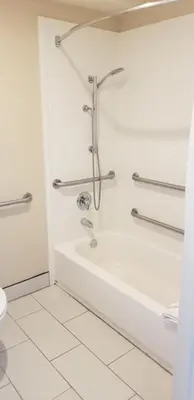 a bathroom with a shower and a tub and a toilet at Quality Inn & Suites Anaheim Maingate in Anaheim
