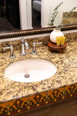 a bathroom counter with a sink and a mirror at Ayres Hotel Redlands - Loma Linda in Redlands