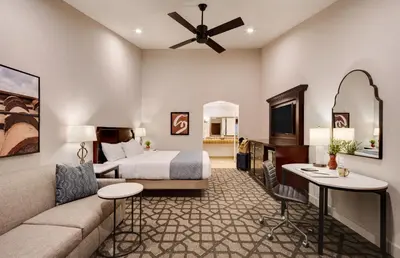 a hotel room with a bed and a couch at Ayres Hotel Redlands - Loma Linda in Redlands