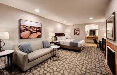 a hotel room with a bed and a couch at Ayres Hotel Redlands - Loma Linda in Redlands