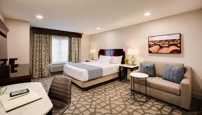 a hotel room with a bed and a couch at Ayres Hotel Redlands - Loma Linda in Redlands