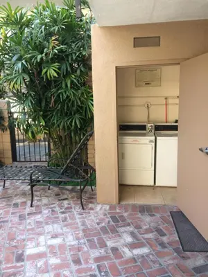 a patio with a bench and a kitchen in a building at Dunes Inn - Wilshire in Los Angeles