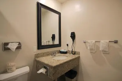 a bathroom with a sink and a mirror at Dunes Inn - Wilshire in Los Angeles