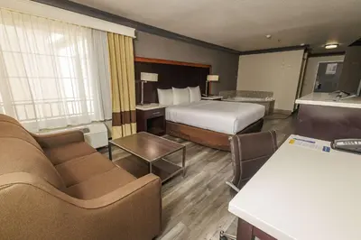 a hotel room with a bed and a couch at Comfort Inn & Suites Near Universal - N Hollywood - Burbank in Los Angeles