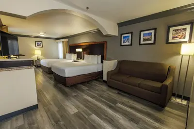 a hotel room with two beds and a couch at Comfort Inn & Suites Near Universal - N Hollywood - Burbank in Los Angeles