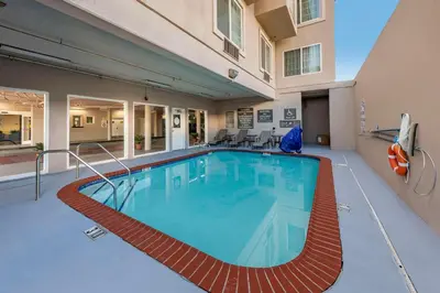 a large swimming pool in the middle of a building at Comfort Inn & Suites Near Universal - N Hollywood - Burbank in Los Angeles