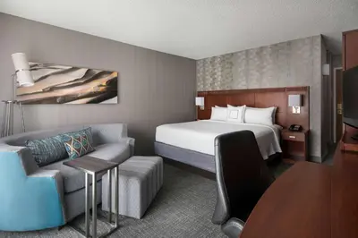 a hotel room with a bed and a couch at Sonesta Select Los Angeles LAX El Segundo in El Segundo