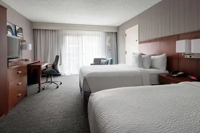 a hotel room with two beds and a desk at Sonesta Select Los Angeles LAX El Segundo in El Segundo
