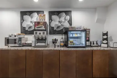 a kitchen with a counter with a coffee maker and appliances at SureStay Hotel by Best Western Beverly Hills West LA in Los Angeles