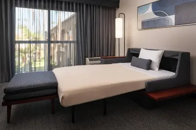 a large bed in a room with a large window at Courtyard by Marriott Los Angeles Hacienda Heights Orange County in Hacienda Heights