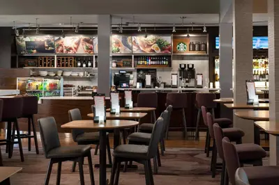 a restaurant with tables and chairs and a bar at Courtyard by Marriott Los Angeles Hacienda Heights Orange County in Hacienda Heights