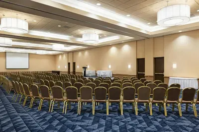 a conference room with chairs and a podium at Courtyard by Marriott Baldwin Park in Baldwin Park