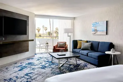 a living room with a blue couch and a tv at Ventura Beach Marriott in Ventura