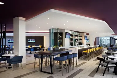 a restaurant with tables and chairs and a bar at Ventura Beach Marriott in Ventura