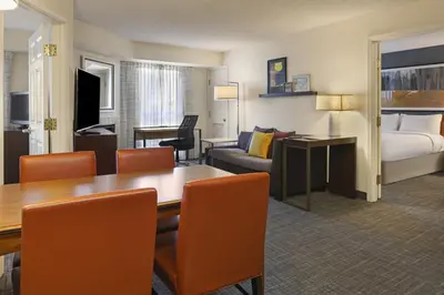 a hotel room with a dining table and a bedroom at Residence Inn Anaheim Hills Yorba Linda in Anaheim