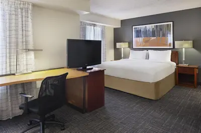 a hotel room with a bed and a desk with a television at Residence Inn Anaheim Hills Yorba Linda in Anaheim