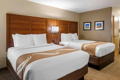 two beds in a hotel room with two at Quality Inn Placentia Anaheim Fullerton in Placentia