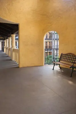 a bench in an empty building with a window at The Buena Park Grand Hotel & Suites in Buena Park