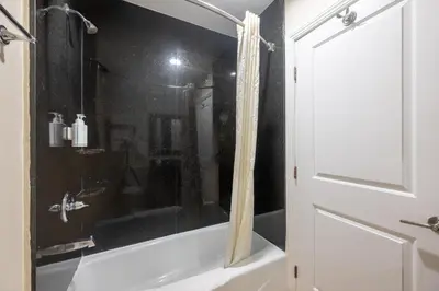 a bathroom with a shower and a bath tub at Hollywood City Inn in Los Angeles
