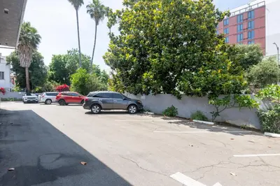 a group of cars parked in a parking lot at Hollywood City Inn in Los Angeles
