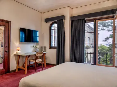 a bedroom with a bed and a table and a desk at Maison Twenty Seven in Los Angeles
