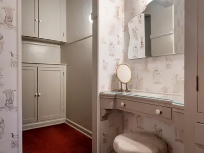 a bathroom with a vanity with a mirror and a stool at Maison Twenty Seven in Los Angeles