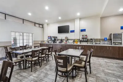 a restaurant with tables and chairs and a counter at Best Western Airpark Hotel - LAX Airport LA Stadium in Inglewood