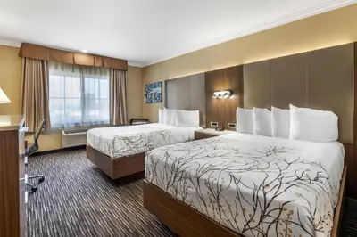 a hotel room with two beds and a window at Best Western Airpark Hotel - LAX Airport LA Stadium in Inglewood