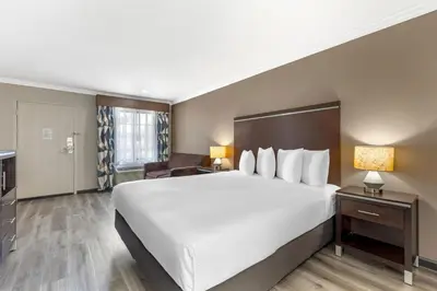 a hotel room with a large bed and a desk at Best Western Redondo Beach Galleria Hotel - Beach City LA in Redondo Beach