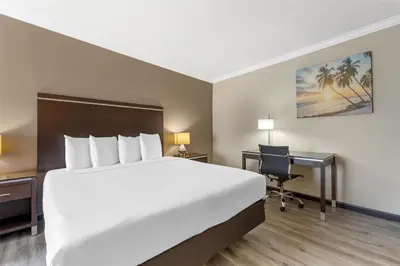 a hotel room with a large bed and a desk at Best Western Redondo Beach Galleria Hotel - Beach City LA in Redondo Beach