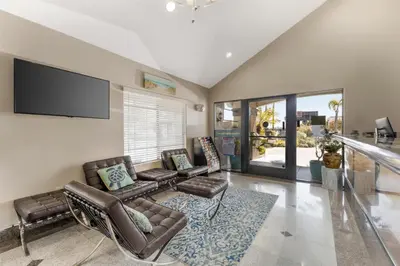 a living room with a couch and chairs and a flat screen tv at Best Western Redondo Beach Galleria Hotel - Beach City LA in Redondo Beach