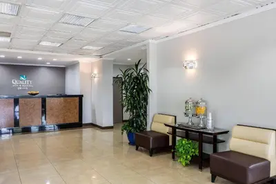 a waiting room at a dental office with a table and chairs at Quality Inn & Suites Los Angeles Airport - Stadium District in Inglewood