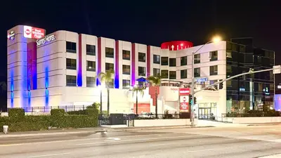 a building with blue and purple lights on it at Best Western Plus Suites Hotel - LAX Airport LA Stadium in Inglewood