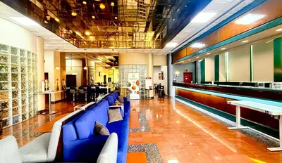 a lobby with a blue couch and a bar at Best Western Plus Suites Hotel - LAX Airport LA Stadium in Inglewood