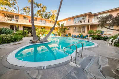 a swimming pool in front of a hotel at Cal Mar Hotel Suites in Los Angeles