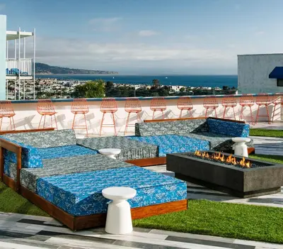 a patio with couches and a fire pit with chairs at Hotel Hermosa in Hermosa Beach