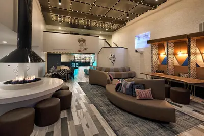 a lobby with couches and a fireplace in a building at Hotel Hermosa in Hermosa Beach