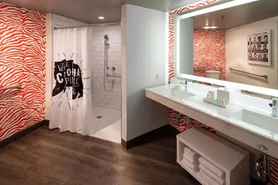 a bathroom with a sink and a shower with a mirror at Hotel Hermosa in Hermosa Beach