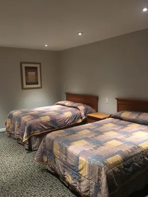 a hotel room with two beds in a room at Century Inn at LAX in Inglewood
