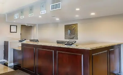 a lobby with a reception counter with two phones at Comfort Inn & Suites Huntington Beach in Huntington Beach