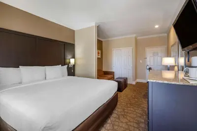 a hotel room with a large bed and a kitchen at Comfort Inn & Suites Huntington Beach in Huntington Beach