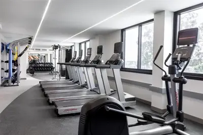 a gym with a row of treadmills and machines at Hilton Garden Inn LAX Los Angeles Airport in Los Angeles
