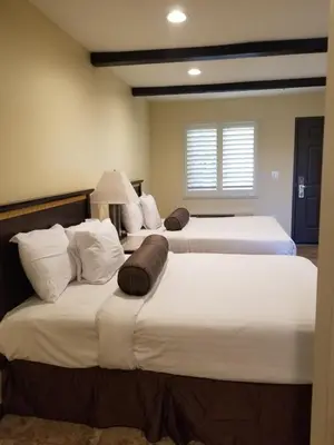 two beds in a room with two beds sidx sidx sidx at Tuscan Garden Inn in Los Angeles
