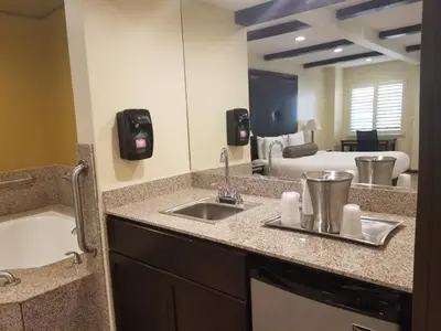 a bathroom with a sink and a bath tub at Tuscan Garden Inn in Los Angeles