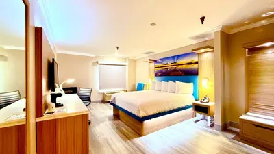 a hotel room with a bed and a television at Days Inn by Wyndham Los Angeles LAX South Bay Beach City LA in Lawndale