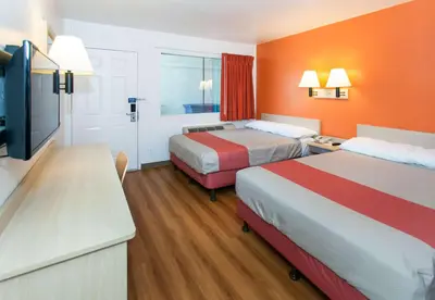 a hotel room with two beds and a flat screen tv at Motel 6-Rosemead, CA - Los Angeles in Rosemead