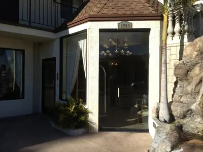 a front door of a house with a clock on it at Jolly Roger Hotel in Los Angeles