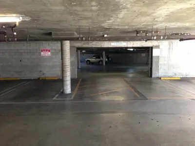 a parking garage with a car parked in it at Jolly Roger Hotel in Los Angeles