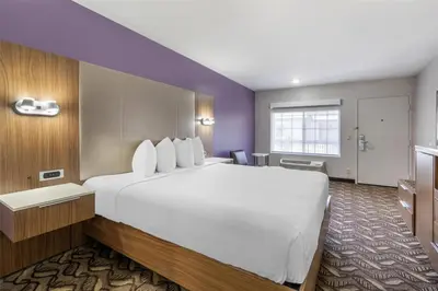 a large white bed in a hotel room at Best Western Airport Plaza Hotel – LAX Airport LA Stadium in Los Angeles